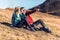 Two travel hikers enjoying the nature while looking the landscape with binoculars in the mountain