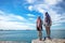 Two traveler young women seeing the beautiful beach and blue sky