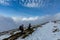 Two trekkers walking above the clouds