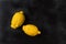 Two trendy organic lemons on a dark background. Horizontal orientation of the image.