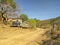 Two trucks parked roadside on dirt road in rural Ixcateopan, Guerrero. Travel in Mexico