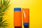 Two tubes with mock up sunscreens on a yellow summer background. UV protection of the skin with an SPF filter, hair care-shampoo