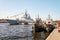 Two tugboats and a warship moored at the Lieutenant Schmidt embankment.