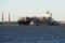 Two tugs pull out the container ship `Elbsailor` to the Kronstadt raid