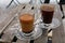 Two Turkish coffee glass cups, black and with milk