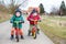 Two twin toddler boys having fun on bicycles