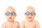 Two twins babies boys wearing glasses.