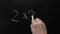 Two and two make four. Hand writing chalk blackboard school simple math addition two multiply two equals four