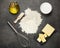 Two types of oil, sour cream and flour for kneading dough, on work surface