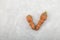 Two ugly carrots on gray background. Expired unused food items. Concept - reduction of organic waste