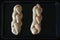 Two uncooked challah sweet bread on a baking tray