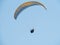 Two undefined people are paragliding in the sky and taking selfies