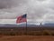 Two Unfurled American Flags with Native American on Horseback Stamped on the Flag with Monument Valley in Background