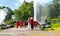 Two unidentifiable people are standing in front of hot spring at San Kamphaeng springs, Thailand