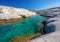 Two unidentifiable women swimming in clear waters of Sarakiniko bay, Milos island, Cyclades, Greece