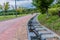 Two unidentified men walking up paved road