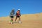 Two unidentified runners running in Wahiba desert
