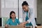 Two uniformed young doctors work in medical clinic office