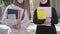 Two unrecognizable Muslim student posing outdoors with book. Front view portrait of confident positive ladies in