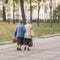 Two unrecognizable senior women walking together in the city, pensioners. Autumn, time, interests elderly, life style