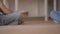 Two unrecognized ittle boys sitting on the floor playing with the toy car sitting on the floor at home. Siblings