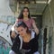 Two urban girls sitting on rusted stairs