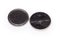 Two used lithium button batteries on white background close-up
