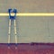 Two used medical crutch at training tennis wall on court,