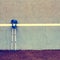 Two used medical crutch at training tennis wall on court,