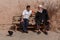 Two uyghur men sitting on a bench having a conversation