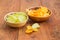 Two various potato chip in ceramic bowls on wooden surface