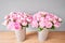 Two vases with peonies for Flowers delivery. Pink Angel Cheeks peonies in a metal vase. Beautiful peony flower for