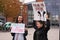 Two vegans protesting against cruelty to animals and eating meat with sign saying spread legs not suffering