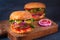 Two veggie burgers on a rustic cutting board