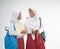 two veiled girls wearing elementary school uniforms chatting with backpacks and a book