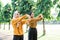 two veiled Muslim girls stretch their hands before jogging and outdoor sports