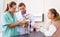 Two veterinarians examine a dog. Girl worries about her pet