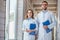 two veterinarians in white coats walking with clipboards in veterinary