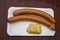 Two Viennese sausages with mustard