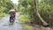 Two Vietnamese women ride their bicycles on a countryside road in the Mekong Delta.