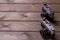 Two vintage cameras stand against a background of brown wooden planks with space for copying