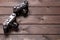 Two vintage cameras stand against a background of brown wooden planks with space for copying