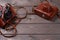 Two vintage cameras stand against a background of brown wooden planks with space for copying