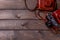 Two vintage cameras stand against a background of brown wooden planks with space for copying