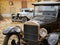 Two vintage cars in the backyard in autumn.