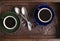Two vintage cups of espresso and spoons on the vintage wooden salver