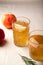 Two vintage glasses with apple cider on linen background