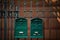 Two vintage green mail boxes