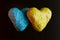 Two volumetric hearts in the colors of the Ukrainian flag on a dark background