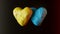 Two volumetric hearts in the colors of the Ukrainian flag on a dark background
